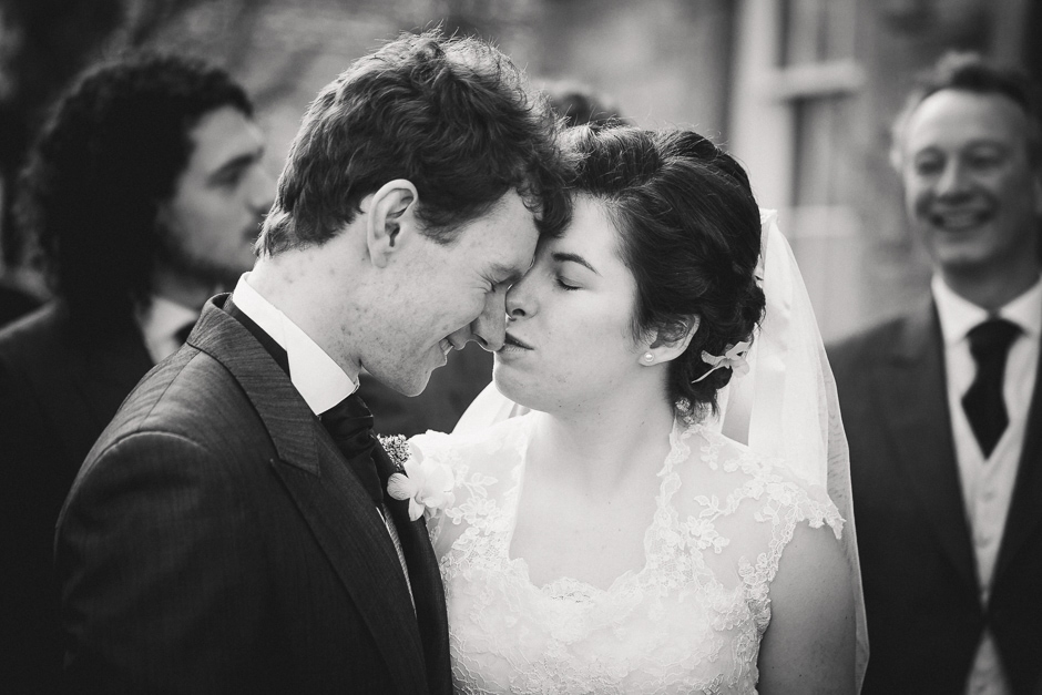 Brides gives Groom a tender kiss